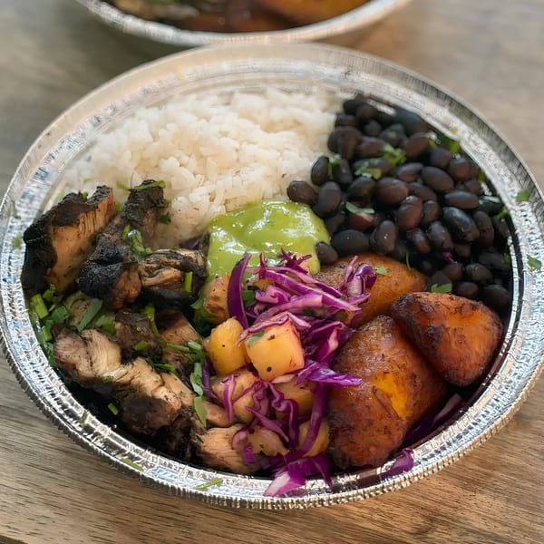 A La Fonda St. Mexican bowl with grilled chicken, rice, black beans, plantains, and pineapple salsa.