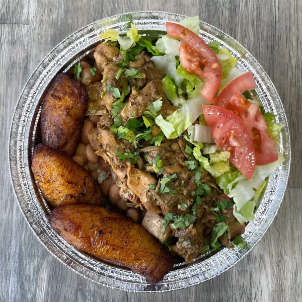 La Fonda St's Mexican dish with chicken, beans, fried plantains, and a side salad in a foil container.