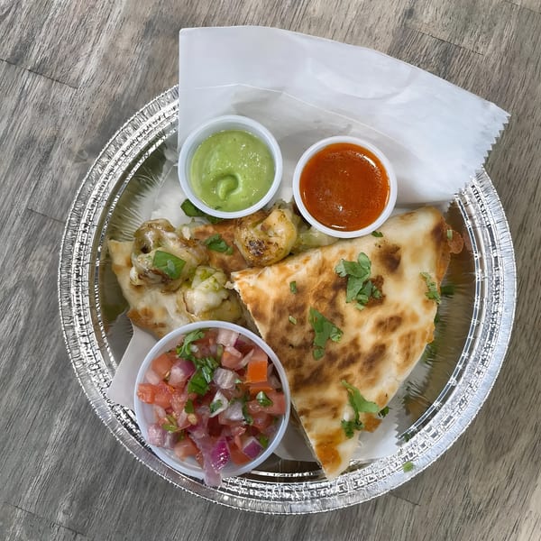 La Fonda St's quesadilla with shrimp, pico de gallo, green sauce, and red sauce in a foil container.
